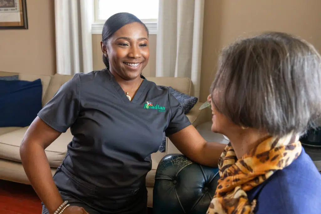 Acadian Health team talking with patient at home